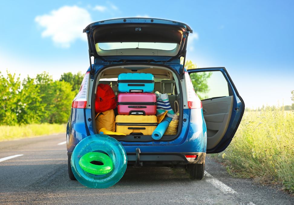 Blauer PKW, der mit Koffern beladen ist